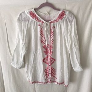 White long sleeve blouse with coral detailing.